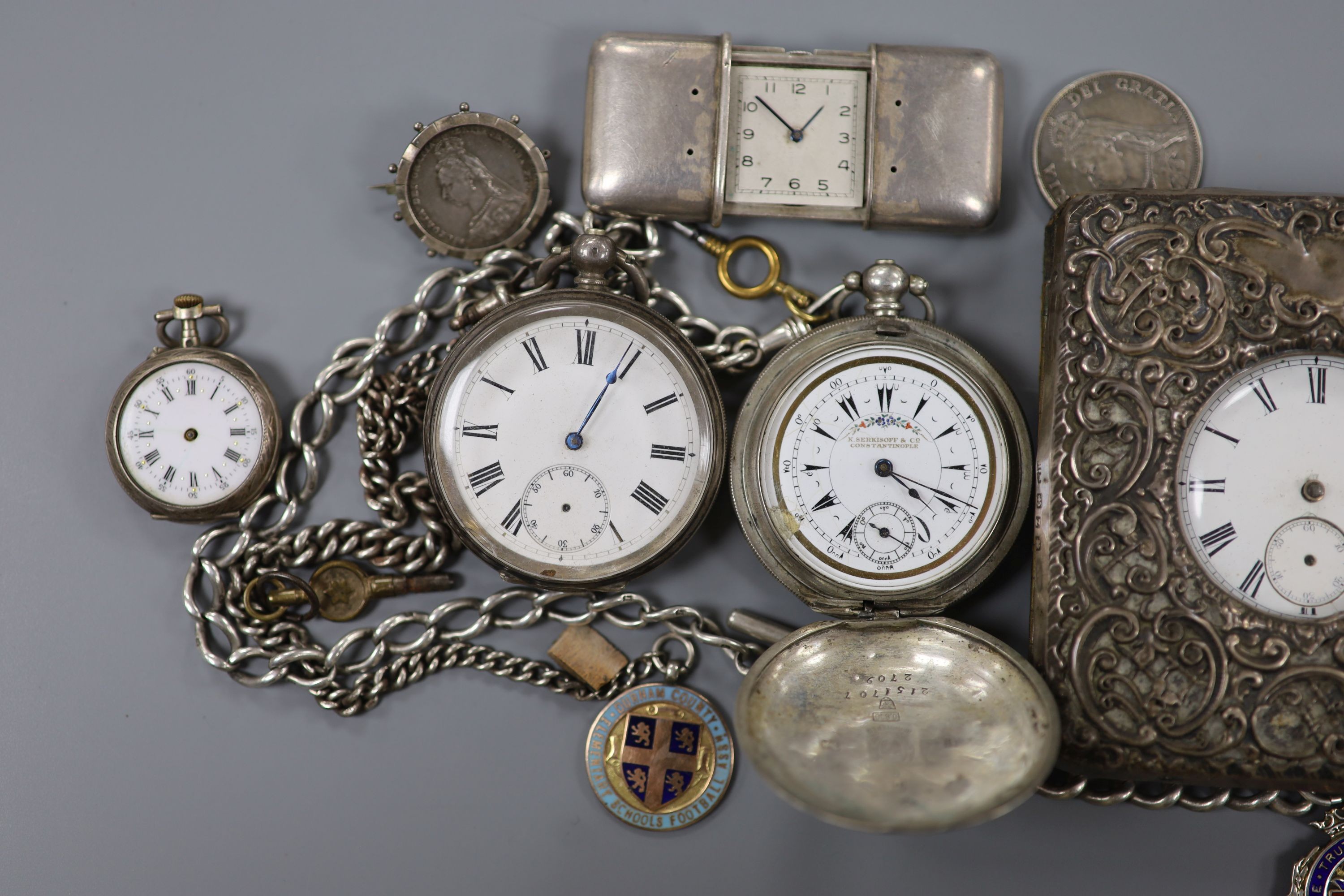 Part of a George III silver pair cased verge pocket watch, A Swiss silver cased travelling watch, five other pocket watches including one in silver mounted travelling case and one with silver albert and two mounted coins